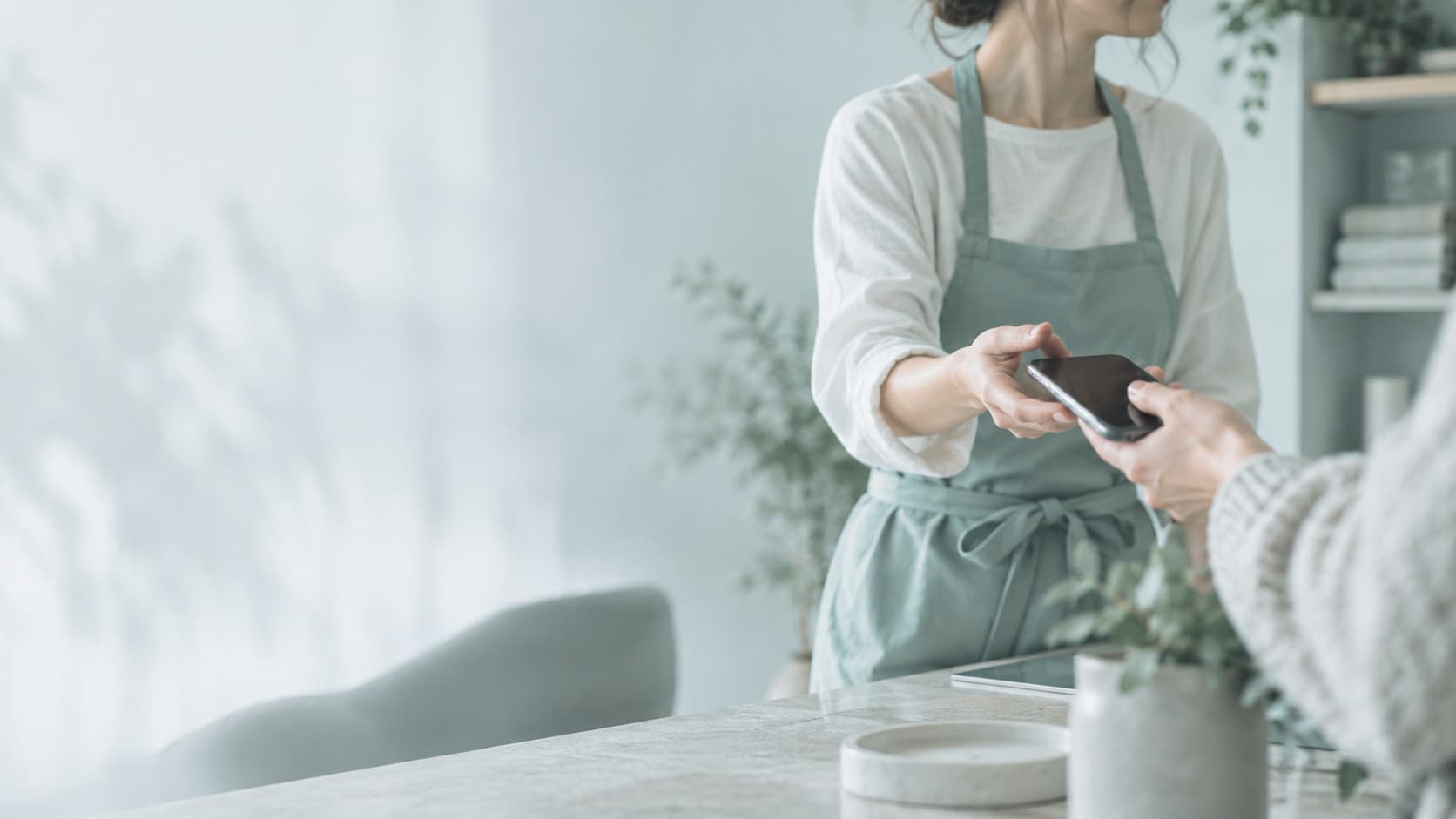 Service business owner reviewing AI customer experience dashboard on a tablet